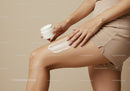 Woman Applying Body Lotion with Skincare Jar in Minimalist Setting