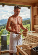 Muscular Man Relaxing in Wooden Sauna with Scenic Mountain View