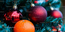 Festive Red Christmas Ornaments on Pine Tree Branch