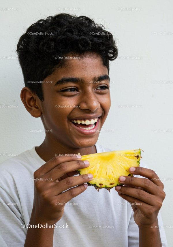 Happy Young Boy Smiling and Holding Pineapple Fruit in Bright Setting