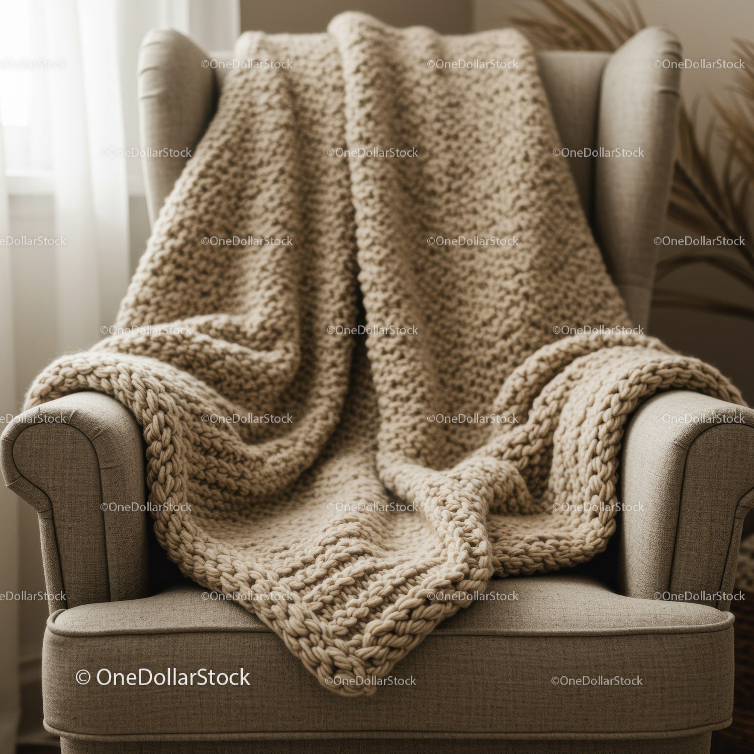 Cozy chunky knit blanket draped on beige armchair