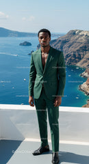 Confident man in green suit by seaside cliff view
