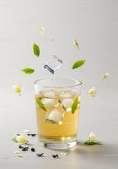 Refreshing iced jasmine tea with fresh flowers and leaves
