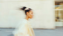Stylish Woman in Motion Wearing Elegant Beige Outfit