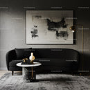 Modern living room with black sofa and abstract art