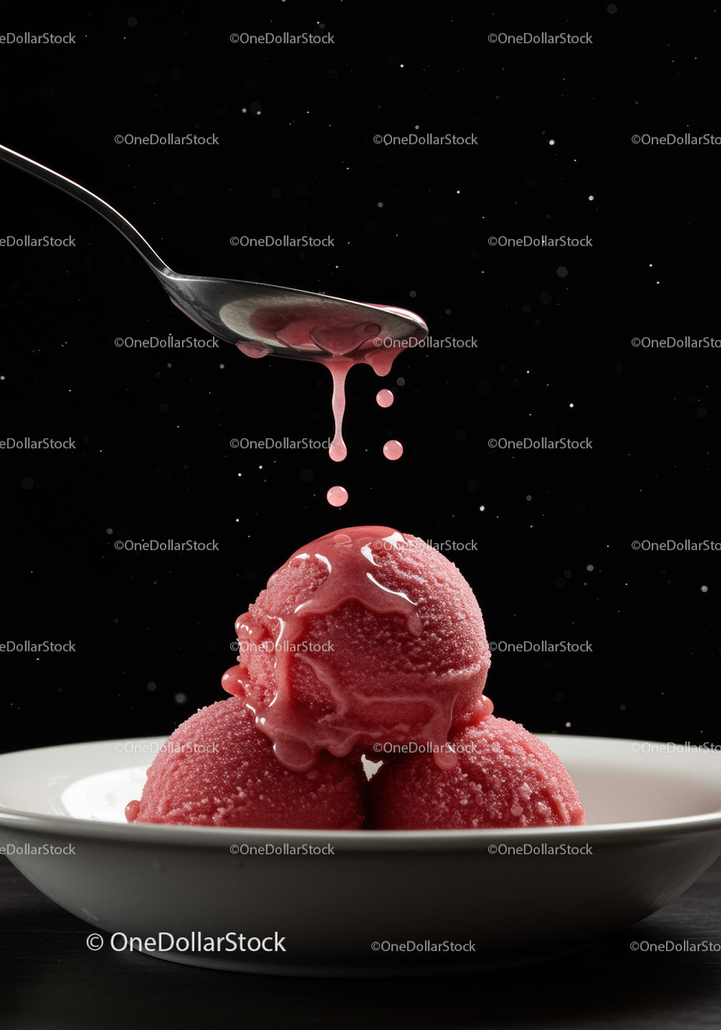 Three scoops of raspberry sorbet with syrup dripping
