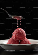 Three scoops of raspberry sorbet with syrup dripping