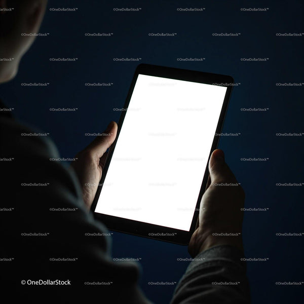 Person Holding Tablet with Bright Screen in Dark Room JPG Mockup Image