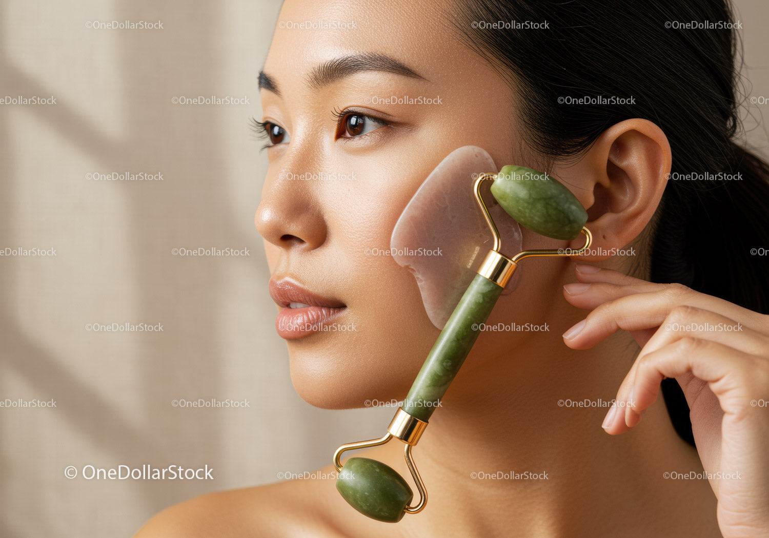 Young Woman Using Jade Roller for Facial Massage and Skin Care