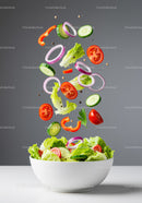 Fresh vibrant vegetables falling into white salad bowl