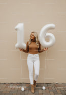 Young woman celebrating sweet sixteen with balloons