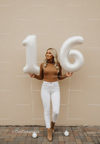 Young woman celebrating sweet sixteen with balloons