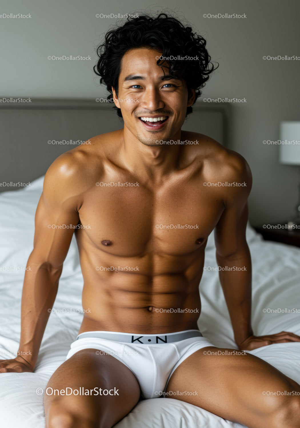 Fit young man sitting on bed in white underwear