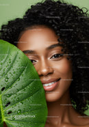 Portrait of a Smiling Woman with Curly Hair and Tropical Greenery