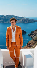 Man in vibrant orange suit standing by seaside cliff
