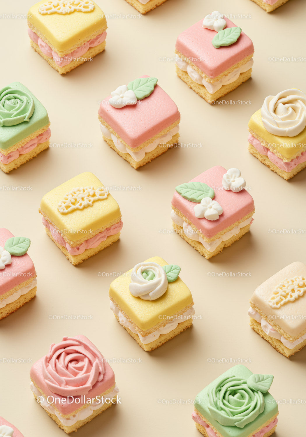 Assorted pastel petit fours with floral decorations