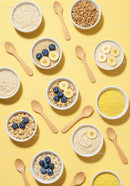 Healthy breakfast bowls with fruits and cereals on yellow