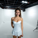 Young Woman in White Dress Smiling in Studio Portrait