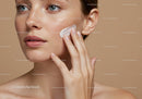 Close-Up of a Woman Applying Facial Moisturizer Over Clear Skin