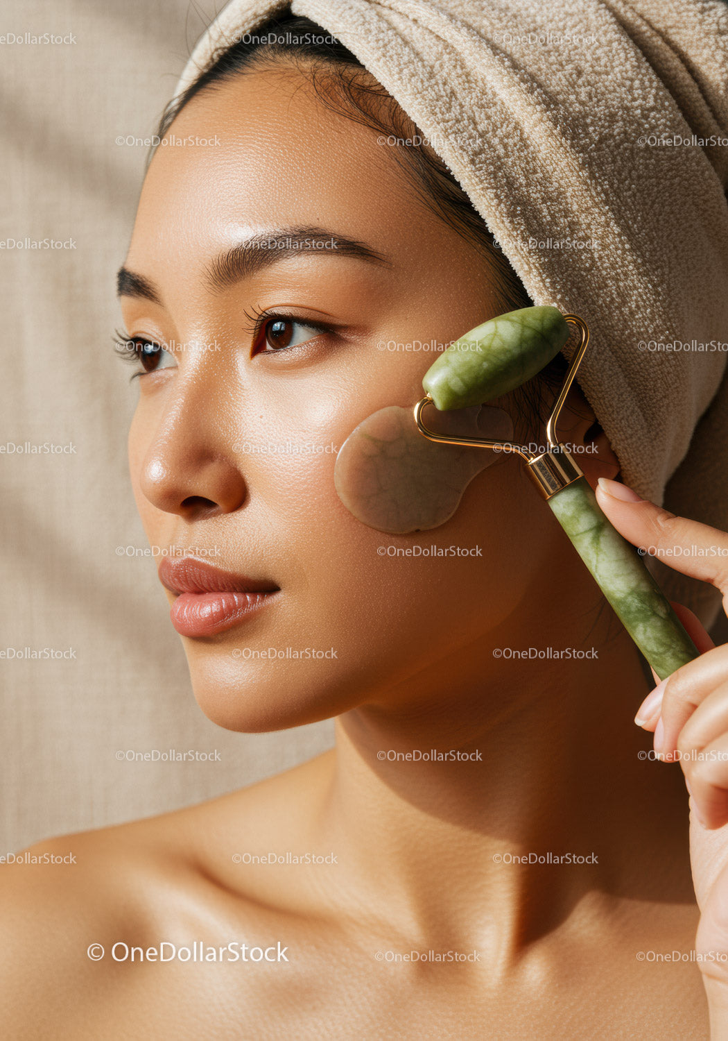 Asian Woman Using Jade Roller for Facial Skincare and Relaxation