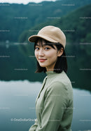 Young Woman in Green Dress Wearing Beige Cap Near Lake Landscape