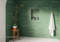 Modern green tiled shower with gold fixtures and plant