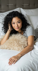 Curly haired woman relaxing on cozy bed