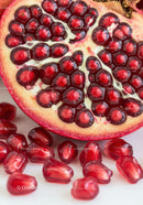 Close up of juicy pomegranate seeds inside fruit half