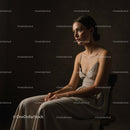 Elegant Woman in Classic Dress Portrait in Moody Studio Setting