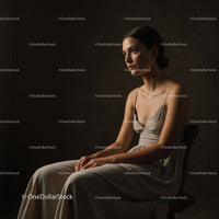 Elegant Woman in Classic Dress Portrait in Moody Studio Setting