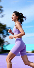Focused young woman running outdoors in purple activewear