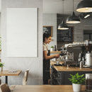 Barista preparing coffee in modern cafe interior