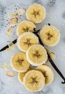 Banana slices with sugar and vanilla on icy background