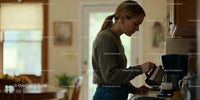 Young woman pouring coffee in cozy kitchen interior