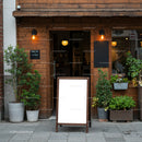 Cozy cafe entrance with blank menu board and plants