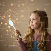 Young girl playing with sparkling light and glitter stars