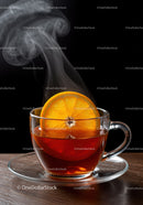 Steaming cup of black tea with fresh orange slice