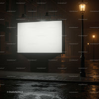 Empty illuminated billboard on wet city street at night