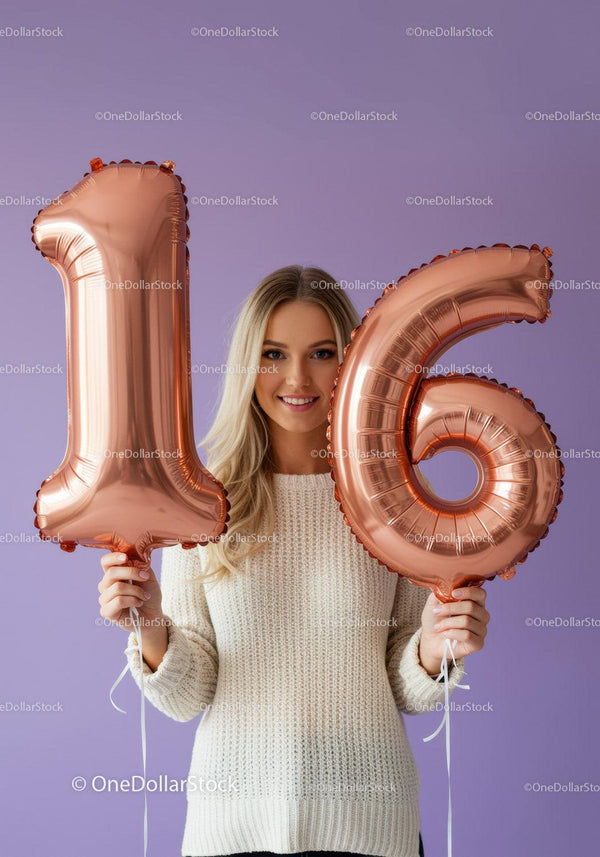 Smiling young woman holding 16 balloons indoors