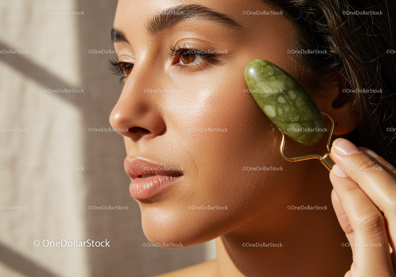 Close-up of Woman Using Jade Roller on Face in Natural Light