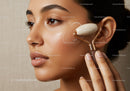 Portrait of a Woman Using a Facial Roller for Skin Rejuvenation