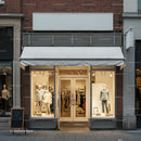 Elegant clothing store window display with mannequins