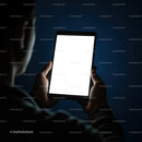 Person Holding Tablet with Bright Screen in Dark Room