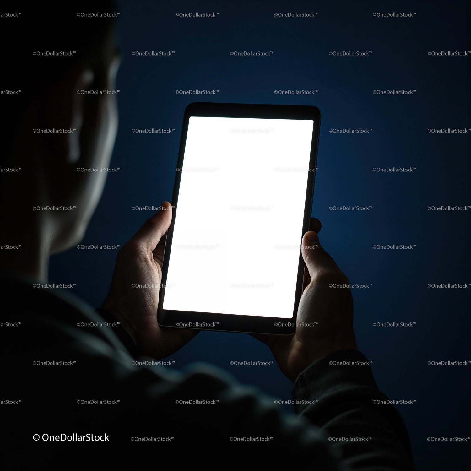 Person Holding Tablet with Bright Screen in Dark Room