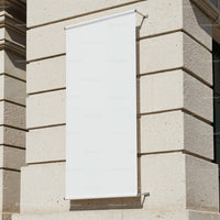 Blank vertical banner on beige stone building wall