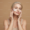 Elegant Mature Woman Applying Facial Cream for Youthful Skin