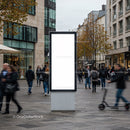 Busy urban street with blank advertising display panel