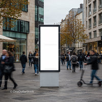 Busy urban street with blank advertising display panel