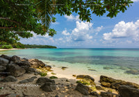Tropical Beach with Clear Blue Water and Rocky Shoreline