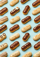 Assorted chocolate and vanilla éclairs on blue surface